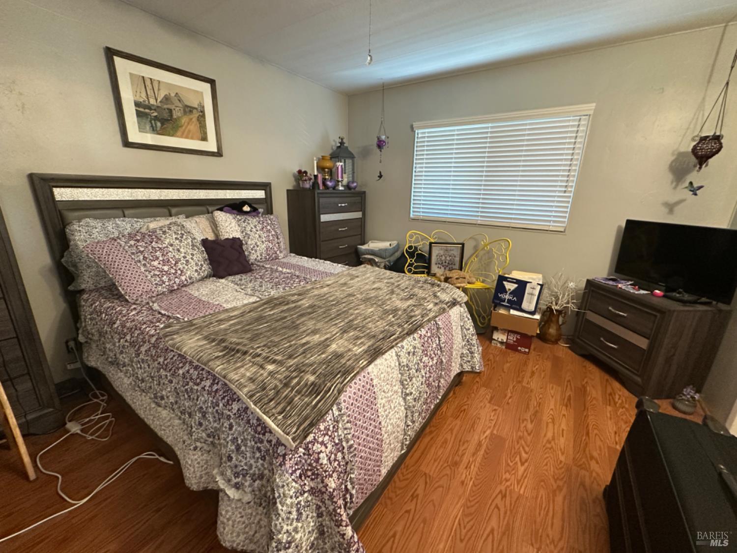 102 Royal Oak Court, Unit 102 Fairfield, CA 94533 - Photo 16 of 32 a bedroom with bed and wooden floor