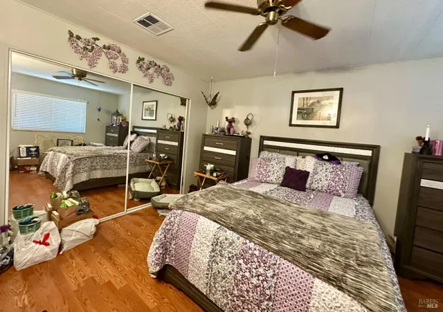 a bedroom with a bed and wooden floor