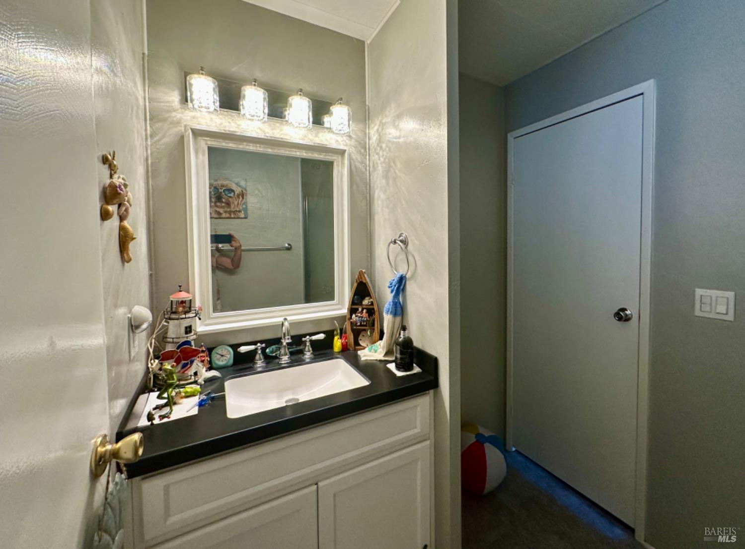 102 Royal Oak Court, Unit 102 Fairfield, CA 94533 - Photo 24 of 32 a bathroom with a sink and a mirror