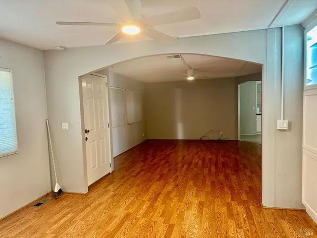 a view of empty room with wooden floor