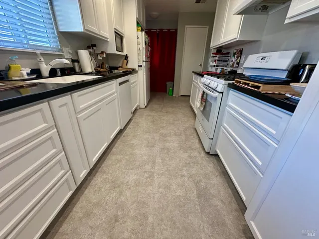 a kitchen with a stove and a refrigerator