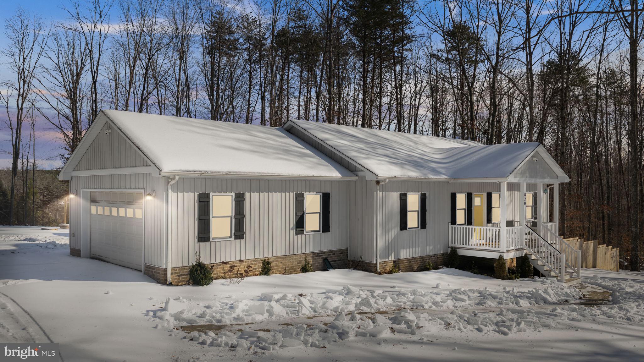 a view of a house with a snow on the road