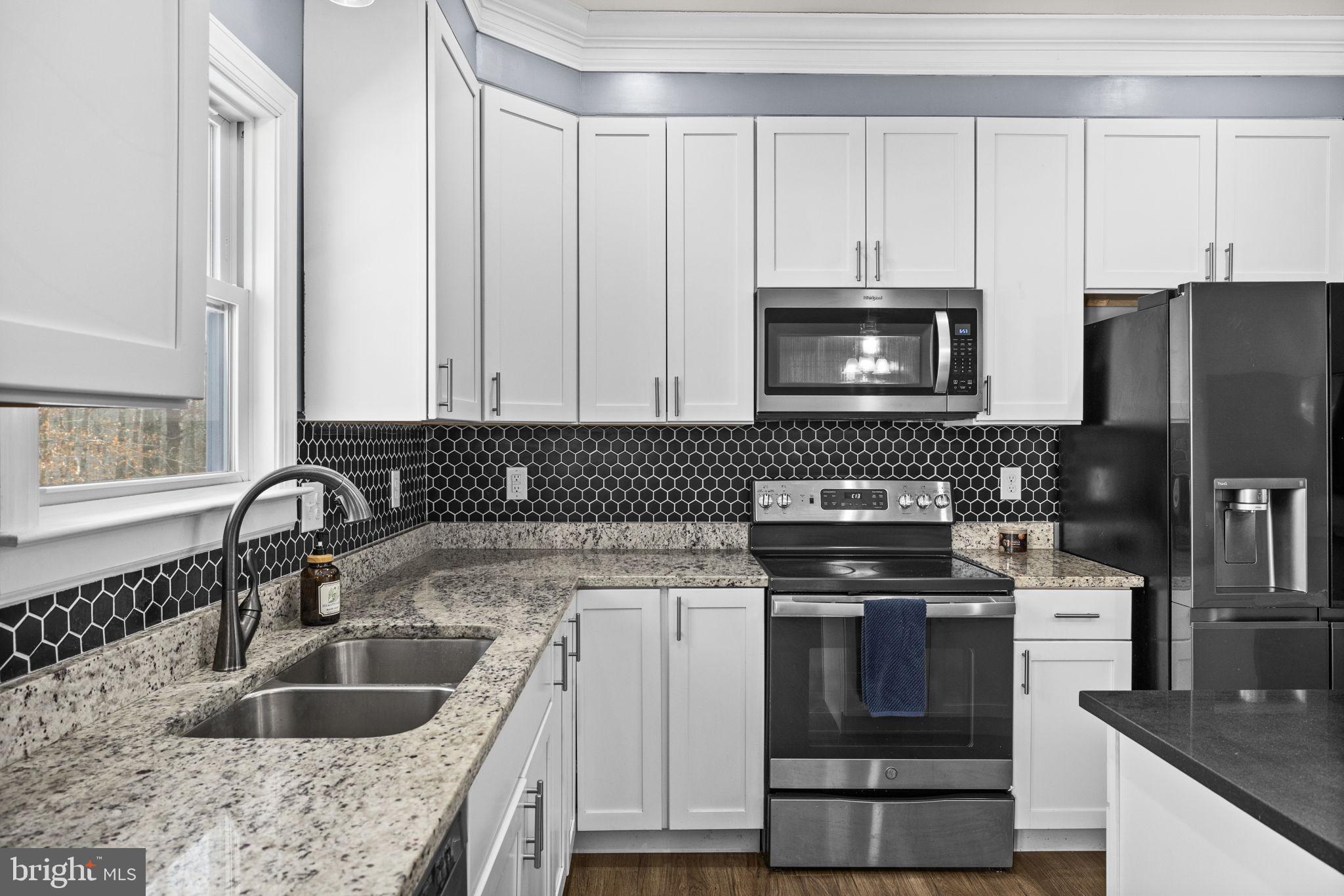 820 Kennon Road Mineral, VA 23117 - Photo 11 of 43 a kitchen with granite countertop a sink a stove and refrigerator