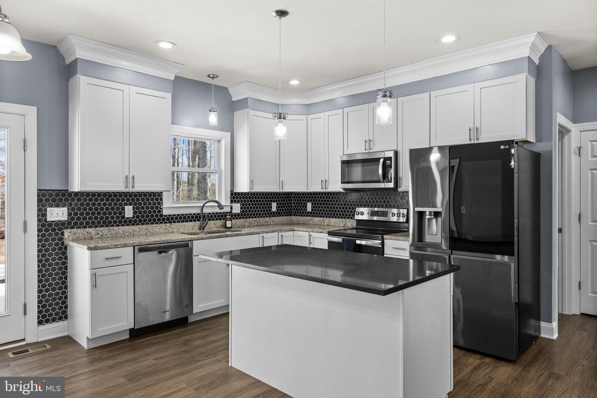 820 Kennon Road Mineral, VA 23117 - Photo 12 of 43 a kitchen with a refrigerator stove microwave and sink