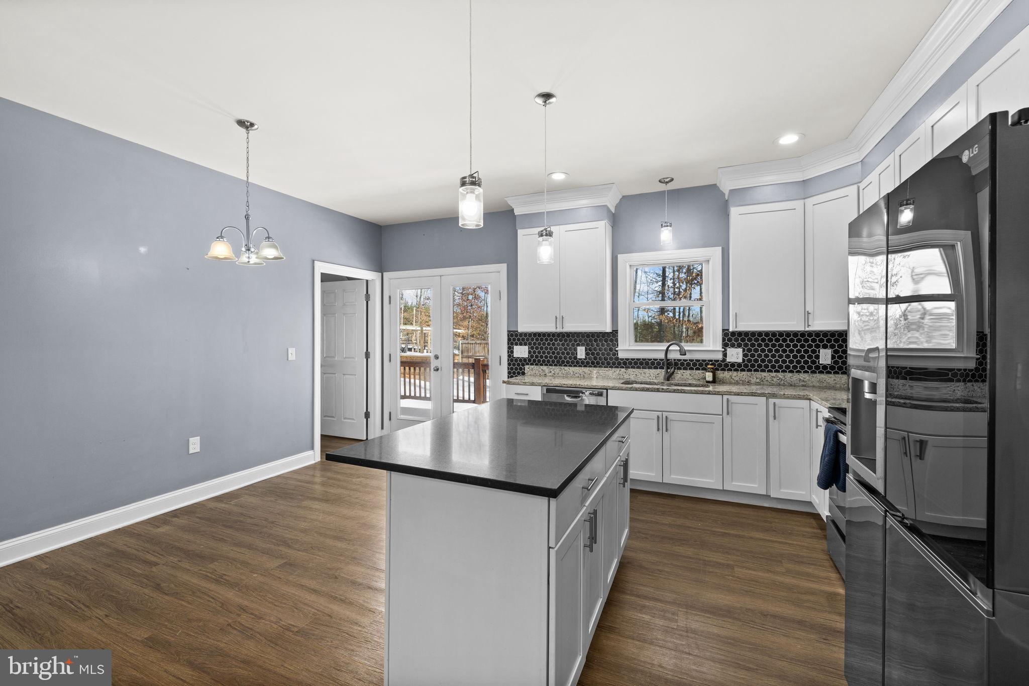 820 Kennon Road Mineral, VA 23117 - Photo 13 of 43 a kitchen with kitchen island a sink appliances and cabinets