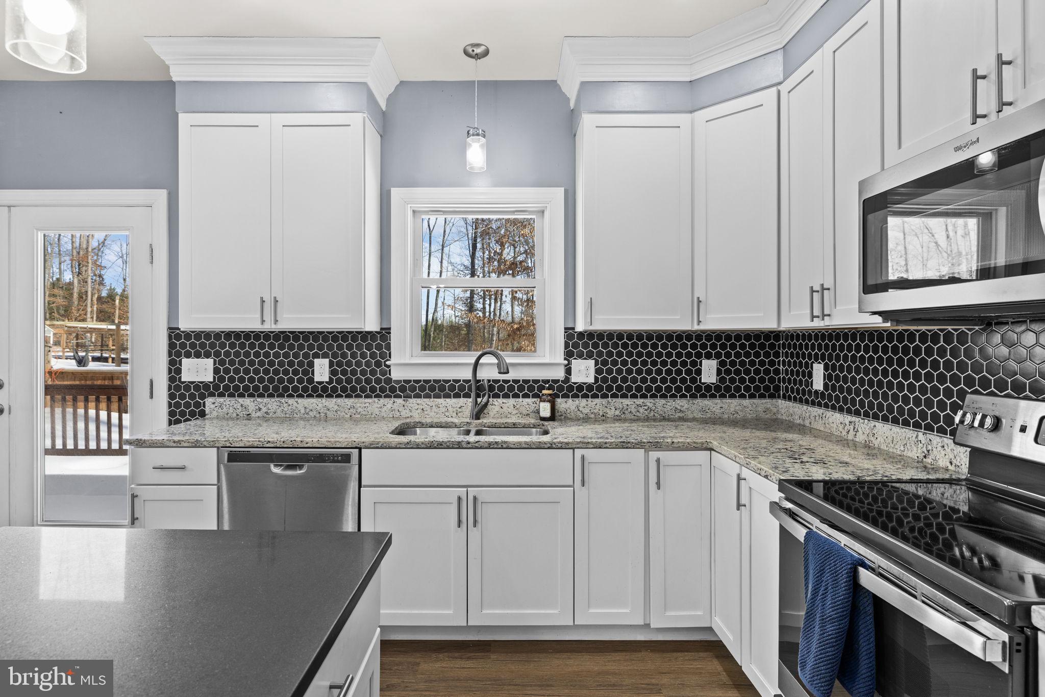 820 Kennon Road Mineral, VA 23117 - Photo 14 of 43 a kitchen with a sink stove top oven and cabinets