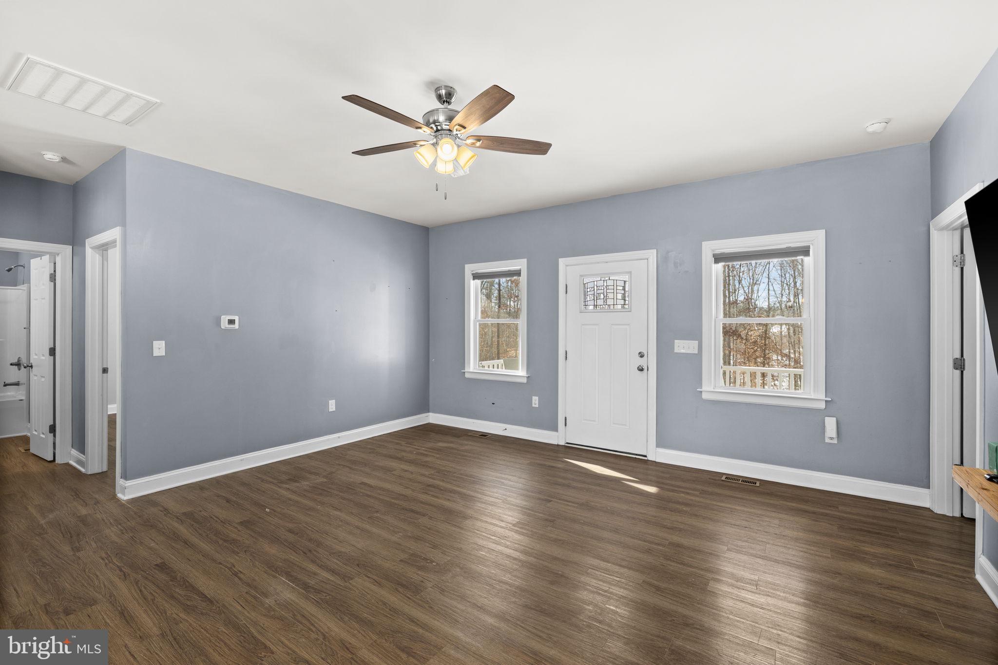 820 Kennon Road Mineral, VA 23117 - Photo 19 of 43 a view of an empty room with wooden floor and a window