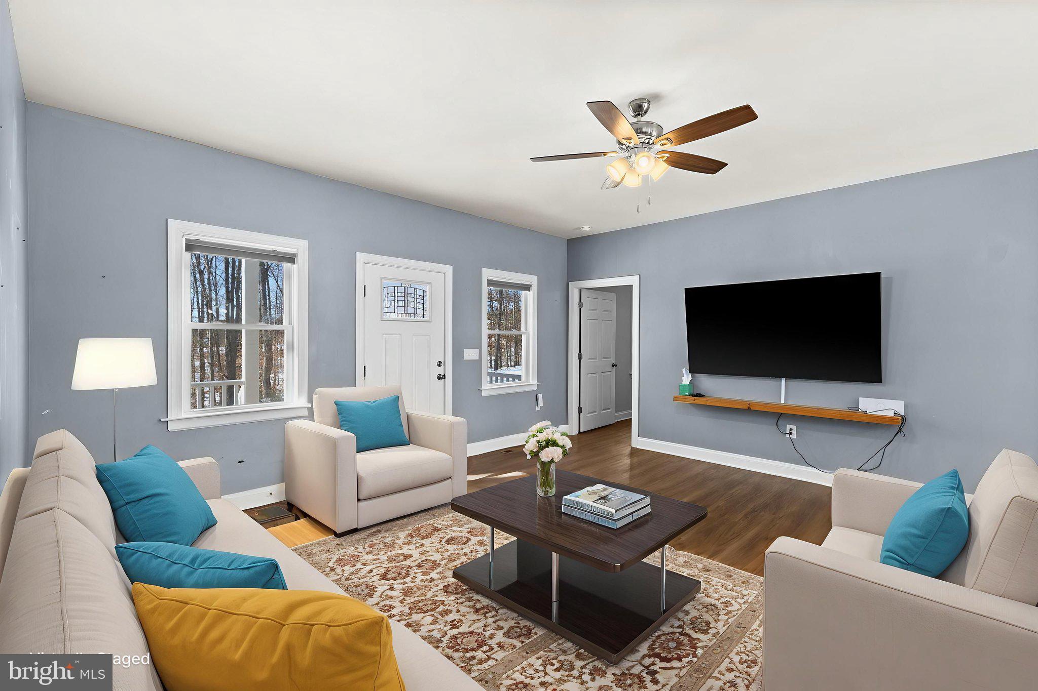 820 Kennon Road Mineral, VA 23117 - Photo 2 of 43 a living room with furniture and a flat screen tv