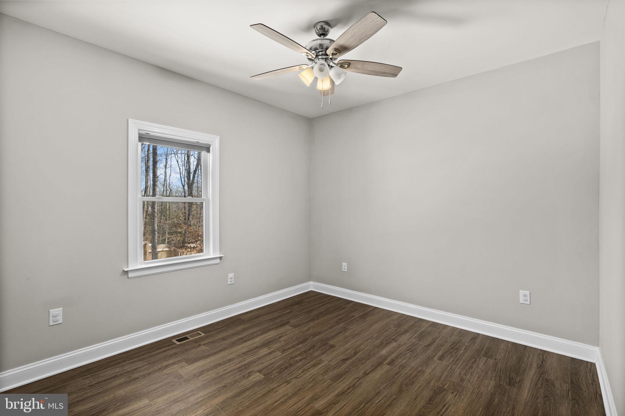 820 Kennon Road Mineral, VA 23117 - Photo 23 of 43 wooden floor in an empty room with a window