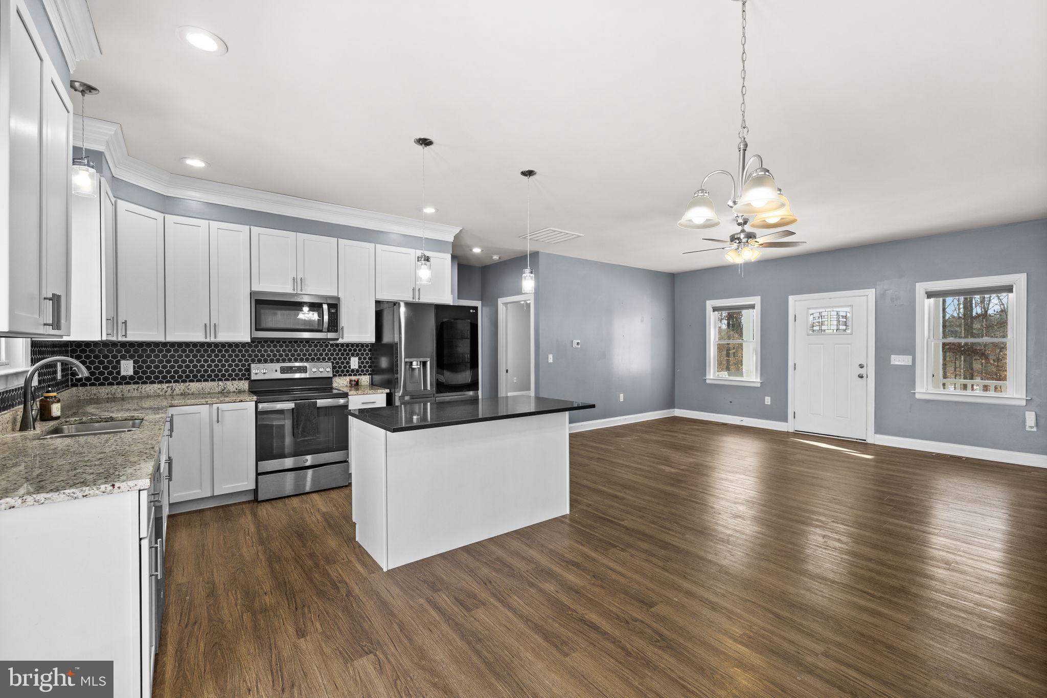 820 Kennon Road Mineral, VA 23117 - Photo 4 of 43 a large kitchen with kitchen island a sink dishwasher a refrigerator and a stove with wooden floor