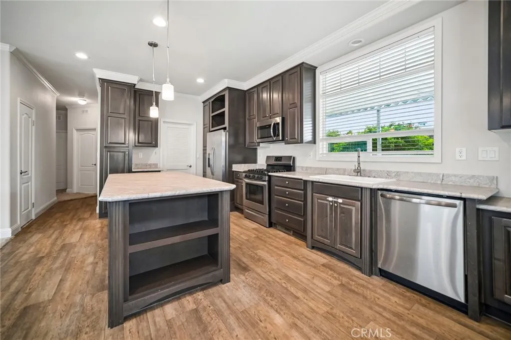 250 East Telegraph Road, Unit 307 Fillmore, CA 93015 - Photo 12 of 36 a large kitchen with kitchen island a sink stainless steel appliances and cabinets