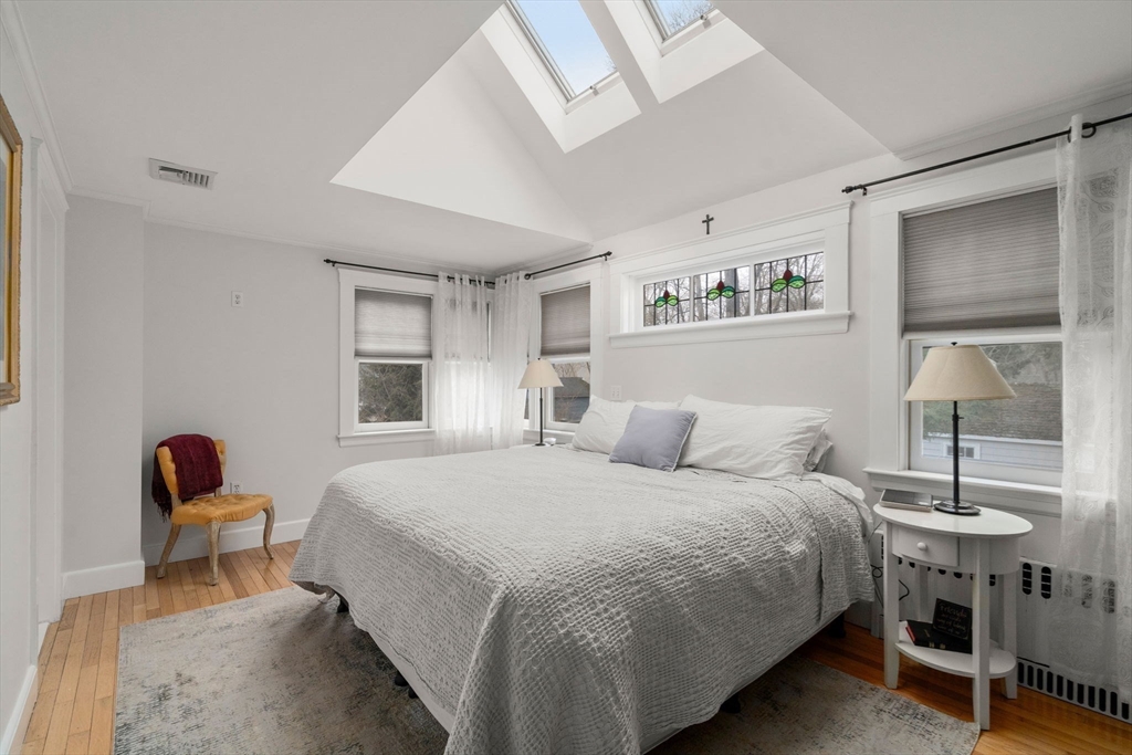 47 Summit Road Wellesley, MA 02482 - Photo 19 of 42 a bedroom with a bed and a table in it