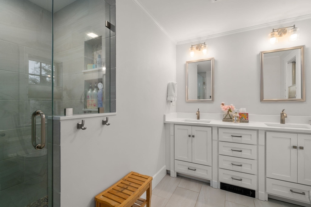 47 Summit Road Wellesley, MA 02482 - Photo 21 of 42 a bathroom with a double vanity sink a mirror a shower and vanity