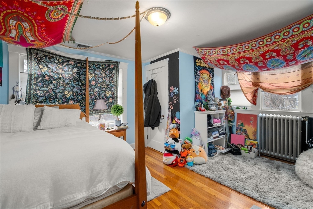 47 Summit Road Wellesley, MA 02482 - Photo 24 of 42 a bedroom with a bed a couch and a chandelier