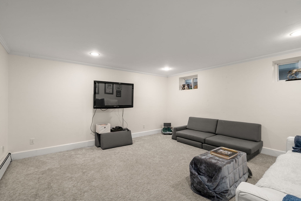 47 Summit Road Wellesley, MA 02482 - Photo 28 of 42 a living room with furniture and a flat screen tv