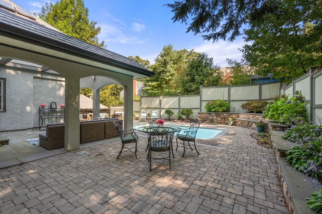 47 Summit Road Wellesley, MA 02482 - Photo 35 of 42 a view of a patio with table and chairs and potted plants