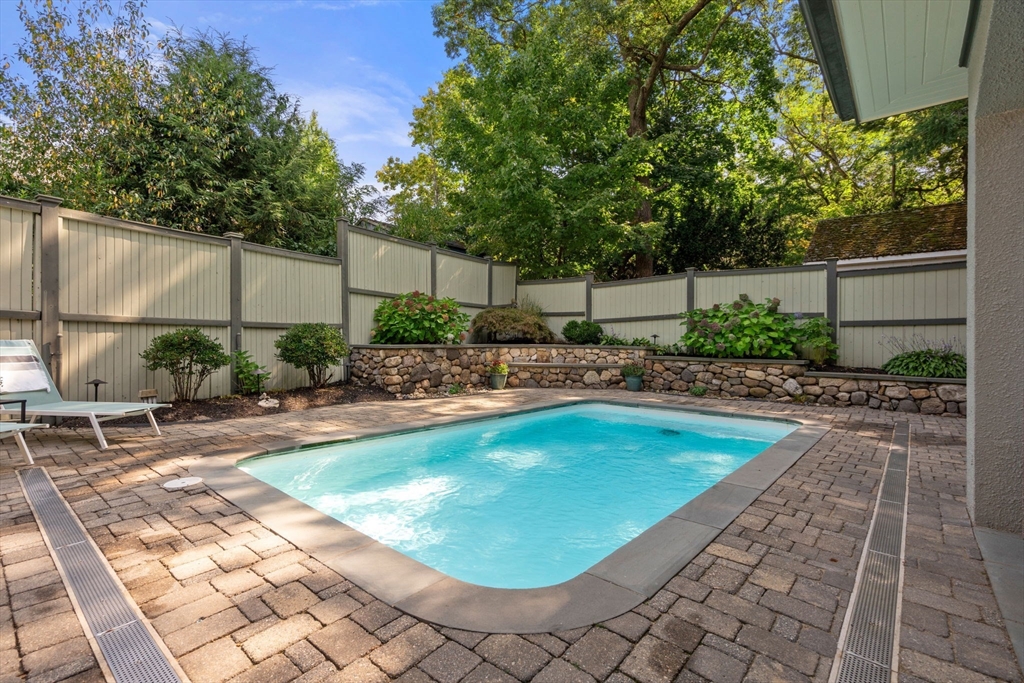 47 Summit Road Wellesley, MA 02482 - Photo 38 of 42 a swimming pool with outdoor seating and yard