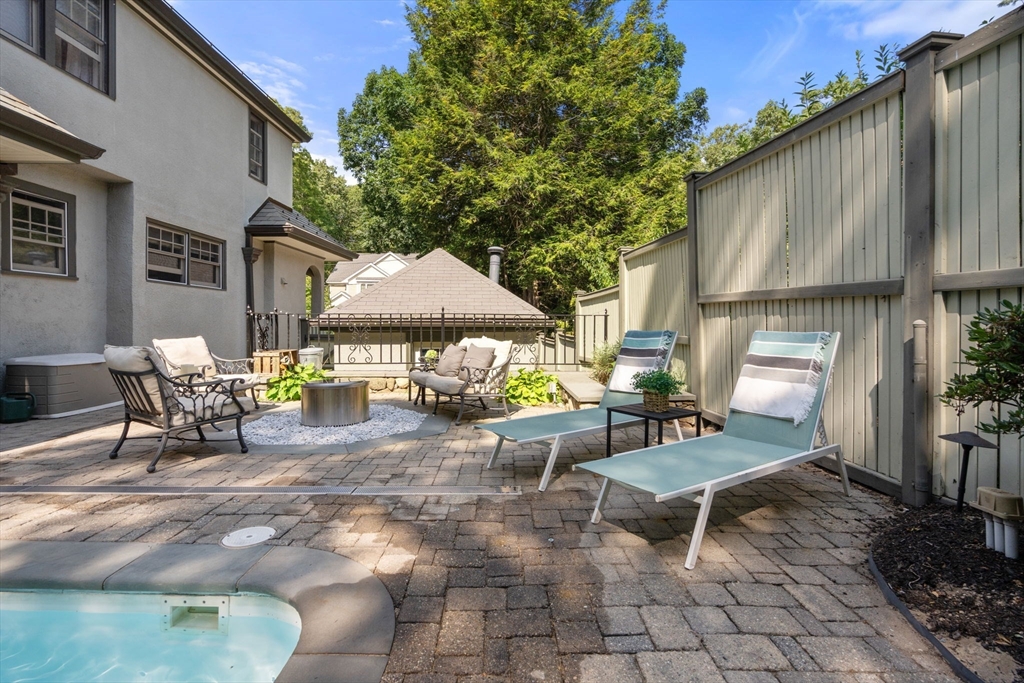 47 Summit Road Wellesley, MA 02482 - Photo 40 of 42 a view of a patio with table and chairs under an umbrella