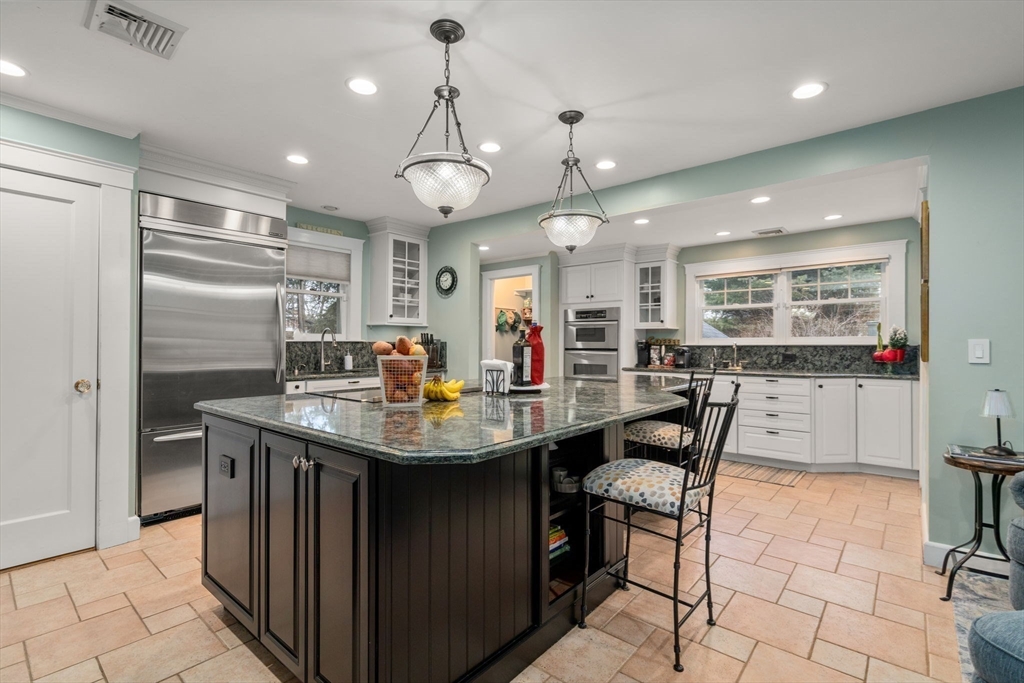 47 Summit Road Wellesley, MA 02482 - Photo 7 of 42 a kitchen with stainless steel appliances granite countertop a sink a stove and a refrigerator
