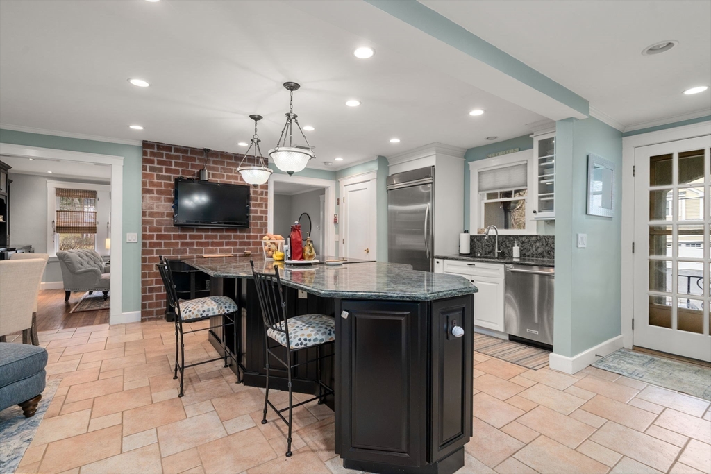 47 Summit Road Wellesley, MA 02482 - Photo 9 of 42 a kitchen with granite countertop a sink a counter top space appliances and cabinets