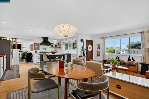 a view of a dining room with furniture and a rug