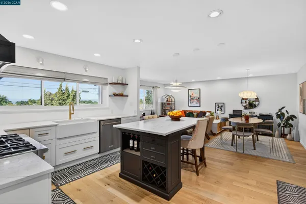 a living room with furniture a counter top space and a refrigerator