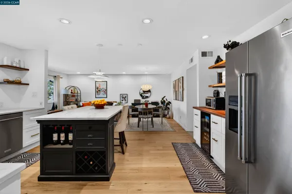 a kitchen view of dining table chairs and wooden floor