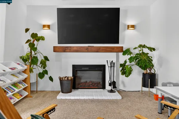 a view of a livingroom with furniture and a flat screen tv