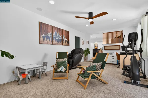 a living room with furniture gym equipment and a window