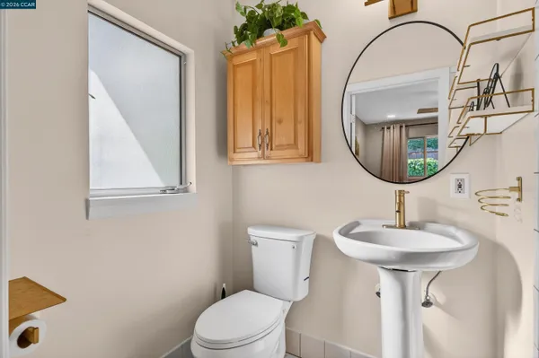 a bedroom with a bed and a dresser next to a window