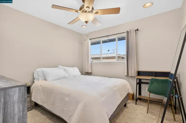 a bedroom with a large bed and a window