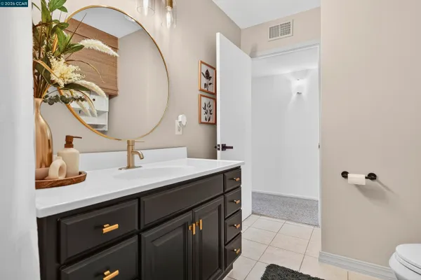 a view of a patio with a table and chairs and a barbeque