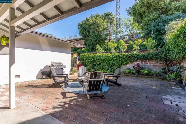 a view of backyard with outdoor seating and plants