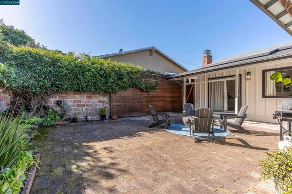 a backyard of a house with outdoor seating