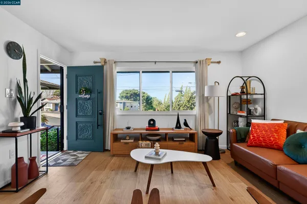 a living room with furniture and a potted plant
