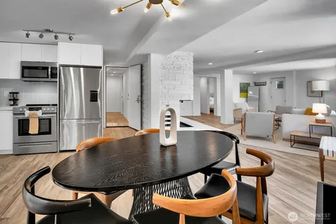 a dining room with furniture and wooden floor