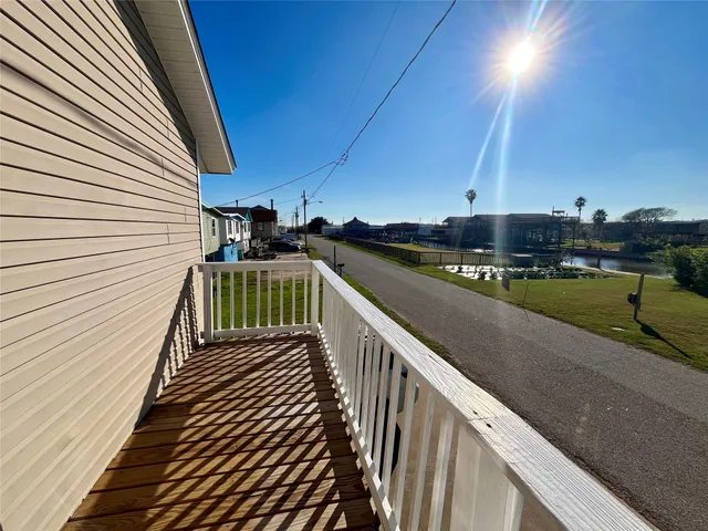 a view of a balcony with wooden floor