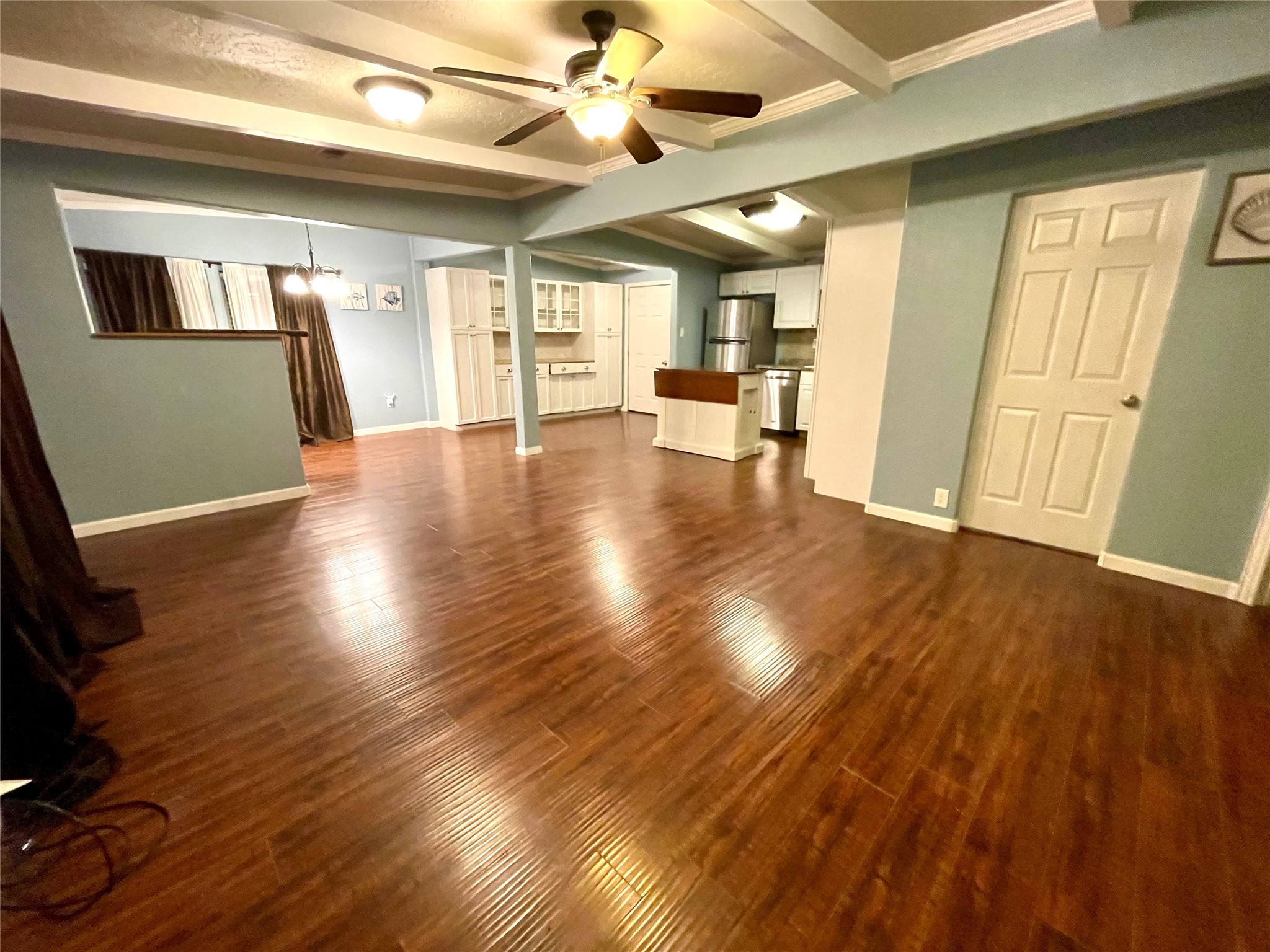 318 Marine Way Freeport, TX 77541 - Photo 5 of 17 a view of an empty room with wooden floor and a kitchen
