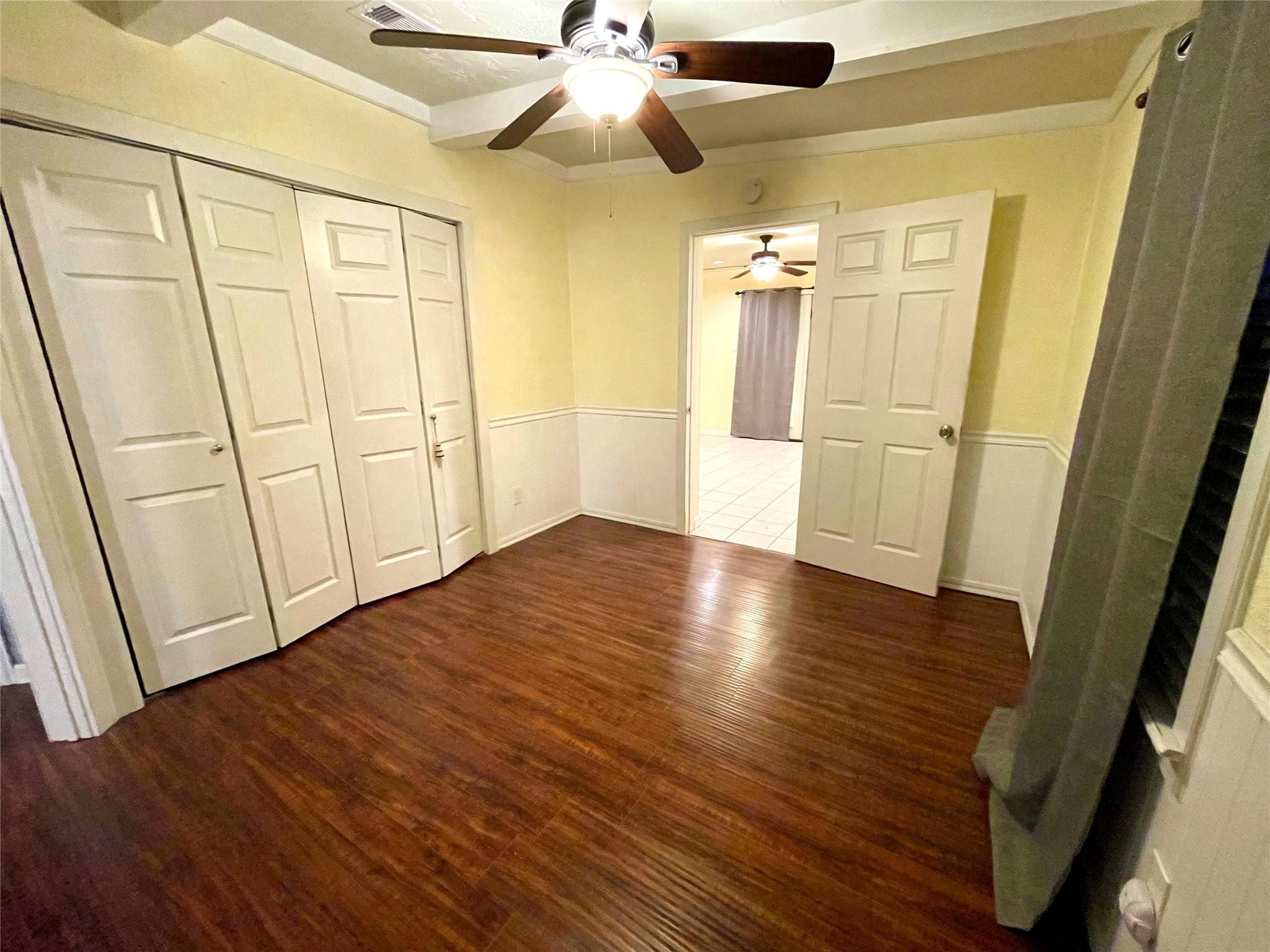 318 Marine Way Freeport, TX 77541 - Photo 9 of 17 an empty room with wooden floor and fan