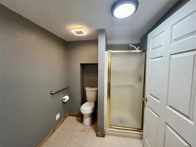 a bathroom with a shower and a toilet