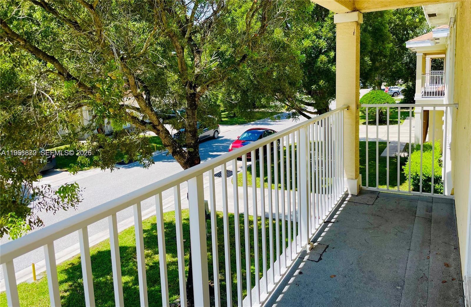 3836 Dove Landing Road West Palm Beach, FL 33403 - Photo 14 of 53 a view of a porch with wooden floor and fence