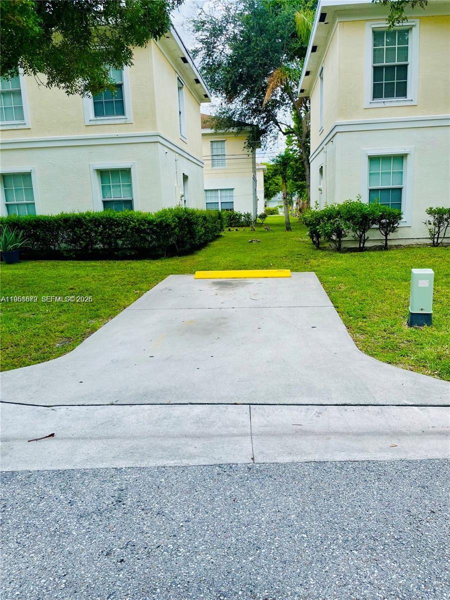 3836 Dove Landing Road West Palm Beach, FL 33403 - Photo 2 of 53 a view of a house with a yard and a garage