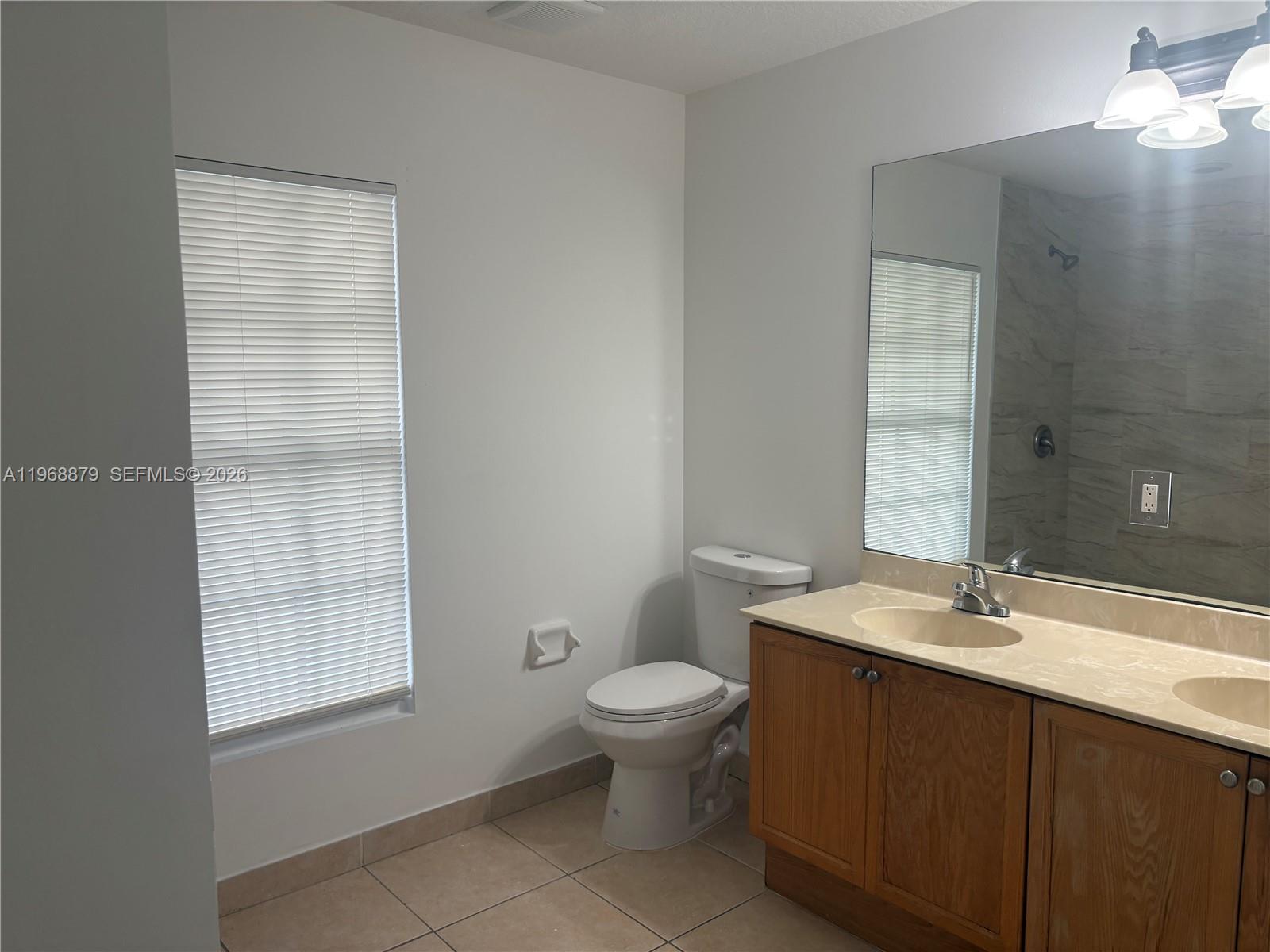 3836 Dove Landing Road West Palm Beach, FL 33403 - Photo 23 of 53 a bathroom with a sink a toilet and shower