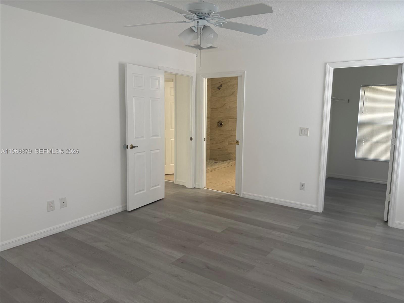 3836 Dove Landing Road West Palm Beach, FL 33403 - Photo 27 of 53 a view of an empty room with wooden floor