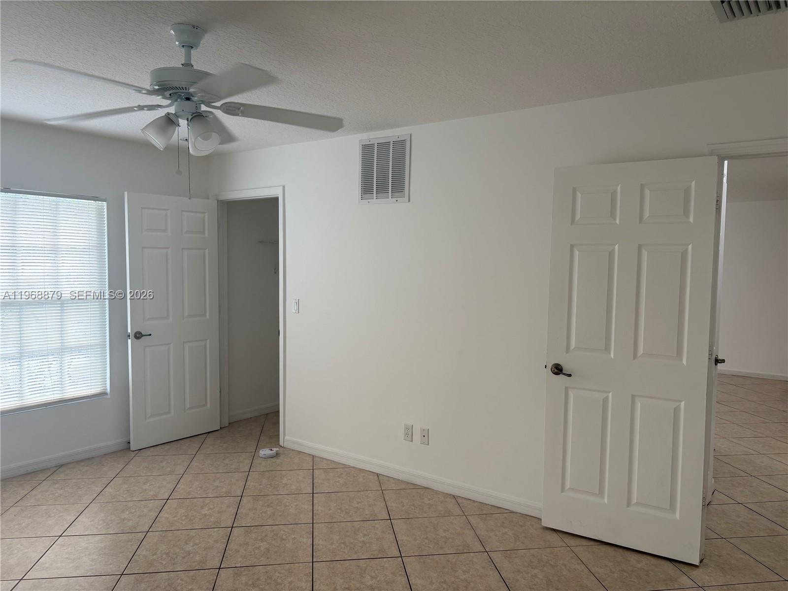 3836 Dove Landing Road West Palm Beach, FL 33403 - Photo 33 of 53 a view of an empty room with a ceiling fan