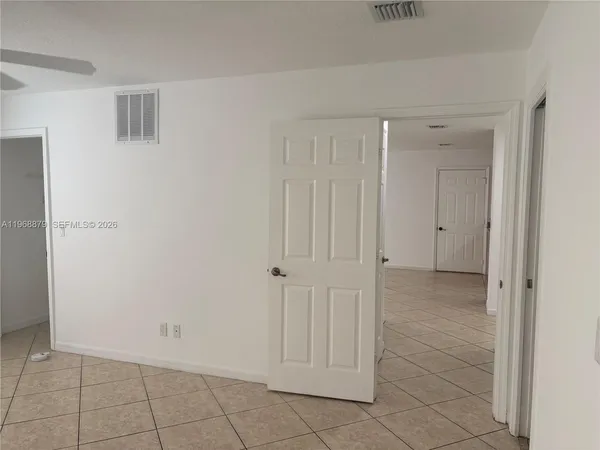a view of a hallway with white doors