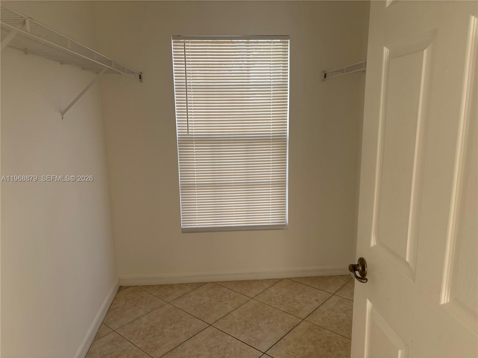 3836 Dove Landing Road West Palm Beach, FL 33403 - Photo 40 of 53 a view of an empty room with a window