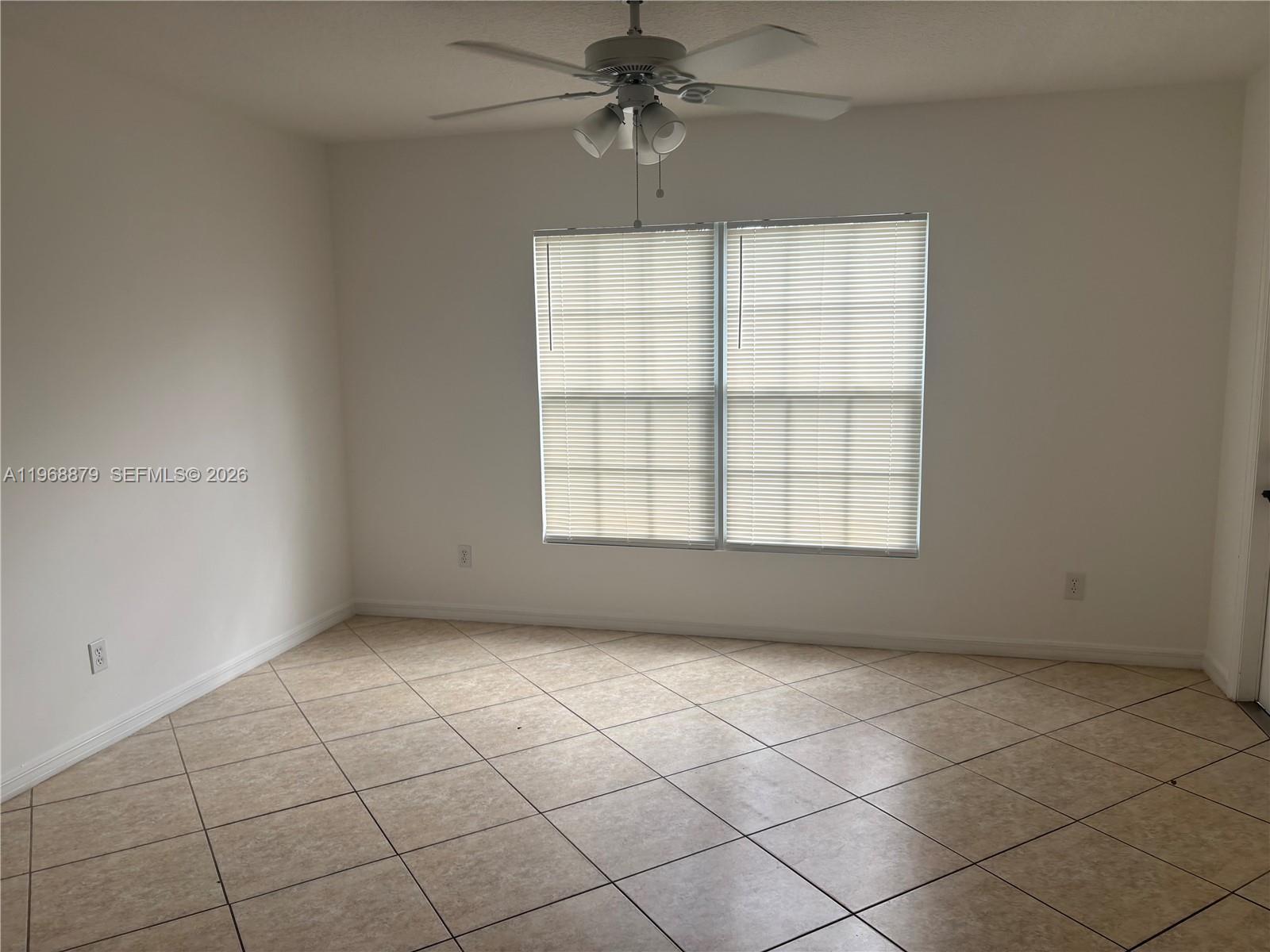 3836 Dove Landing Road West Palm Beach, FL 33403 - Photo 50 of 53 an empty room with windows and ceiling fan