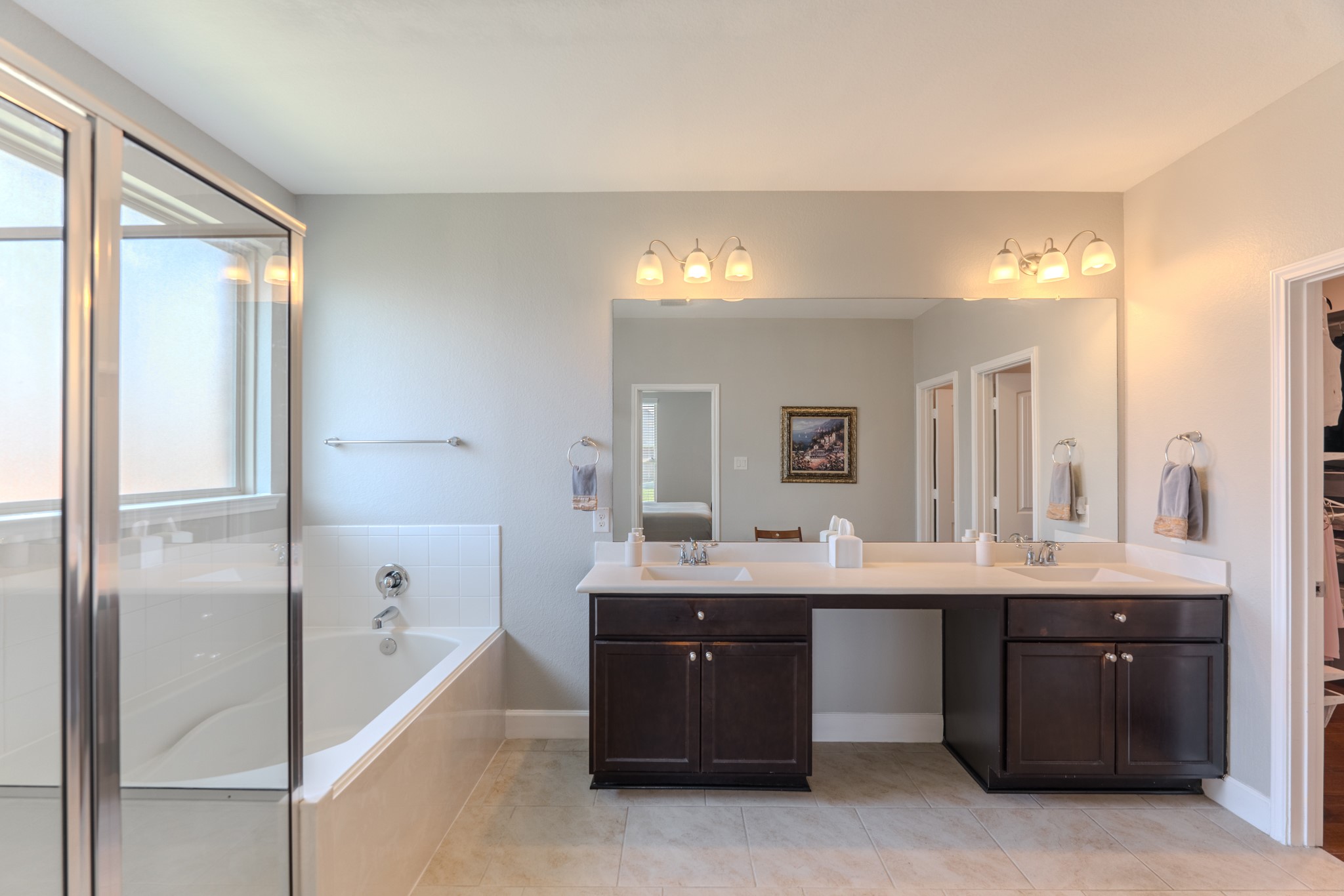24322 North Newcastle Bay Trail Spring, TX 77389 - Photo 29 of 50 a spacious bathroom with a tub double sink and mirror