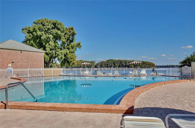 swimming pool view with a seating space